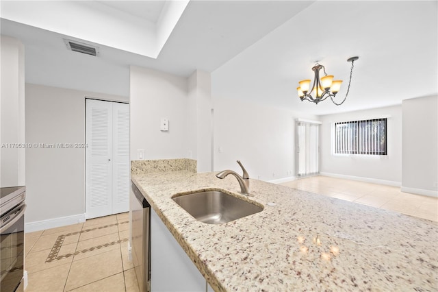 kitchen featuring light stone counters, sink, pendant lighting, light tile patterned floors, and a chandelier