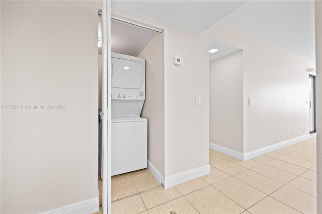 10001 W Atlantic Blvd Unit 316, Coral Springs, FL 33071 - washroom with estacked washer and dryer and light tile patterned floors