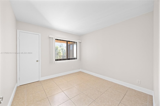 10001 W Atlantic Blvd Unit 316, Coral Springs, FL 33071 - unfurnished room with baseboards and light tile patterned flooring