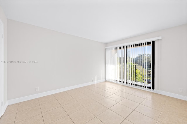 spare room featuring light tile patterned floors