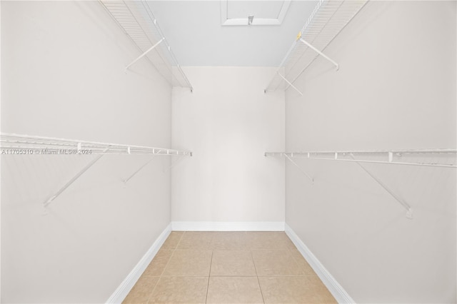 spacious closet with light tile patterned floors