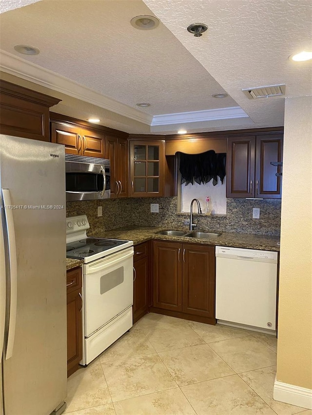 kitchen with sink, stainless steel appliances, crown molding, a textured ceiling, and decorative backsplash