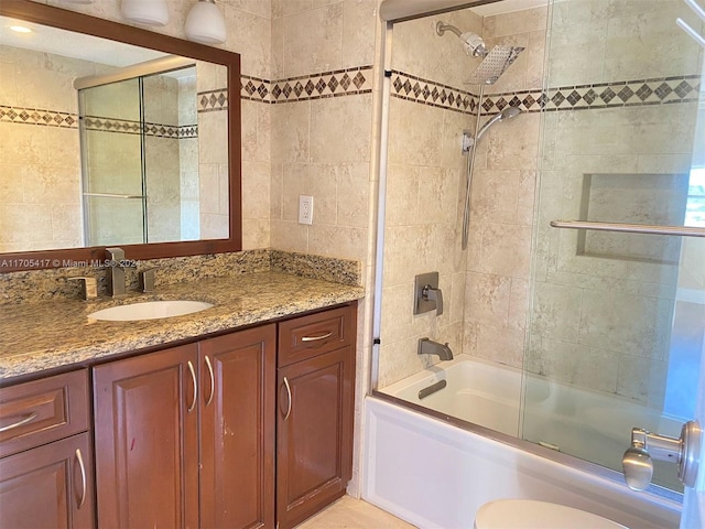 full bathroom with vanity, toilet, and bath / shower combo with glass door