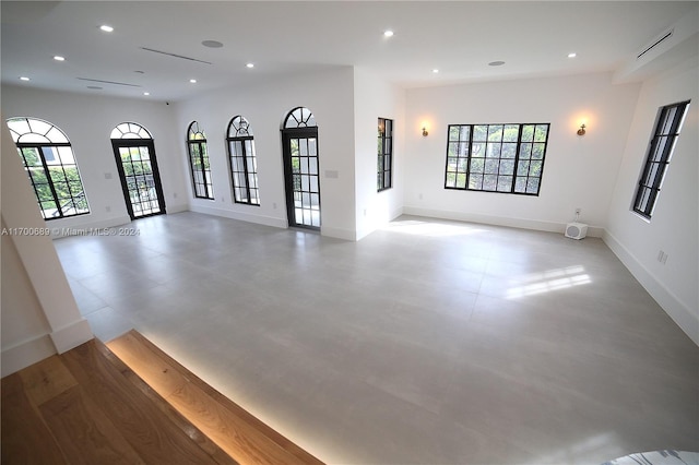 unfurnished living room featuring plenty of natural light