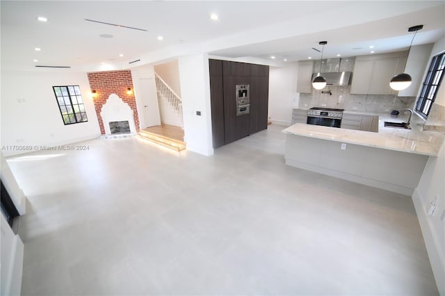 kitchen with ventilation hood, sink, gray cabinets, tasteful backsplash, and stainless steel appliances