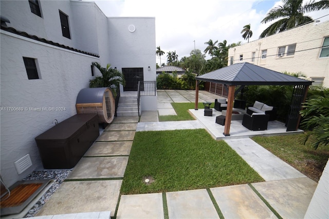 view of yard featuring a gazebo, an outdoor kitchen, a patio, and an outdoor hangout area