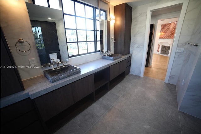 bathroom featuring vanity and tile walls