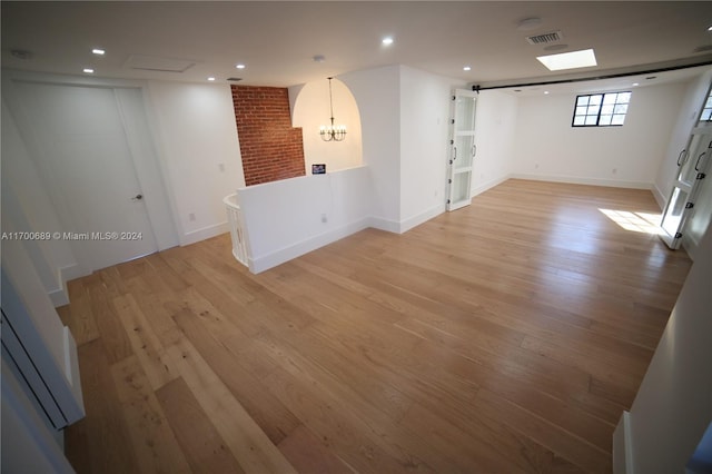 interior space featuring light hardwood / wood-style floors and a notable chandelier