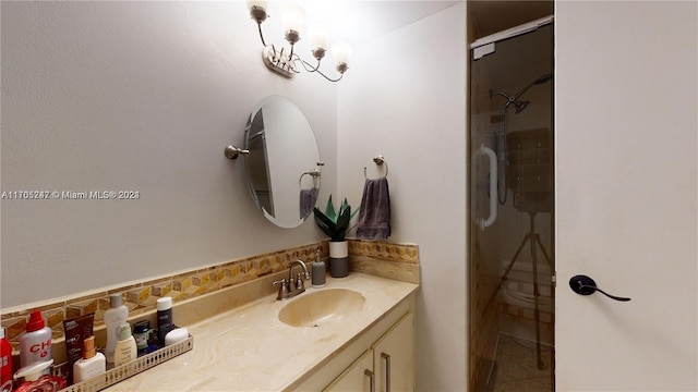 bathroom featuring vanity and an enclosed shower