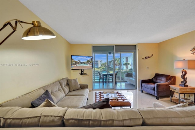 tiled living room featuring a textured ceiling