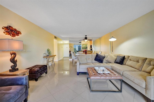 tiled living room featuring a textured ceiling and ceiling fan