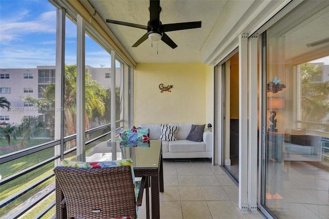 sunroom featuring ceiling fan