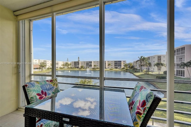 sunroom with a water view and a wealth of natural light