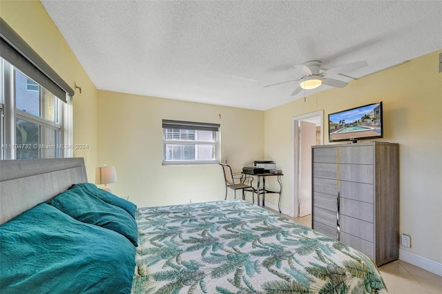 bedroom featuring ceiling fan and a textured ceiling