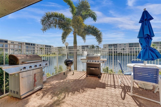 view of patio / terrace featuring a water view and area for grilling