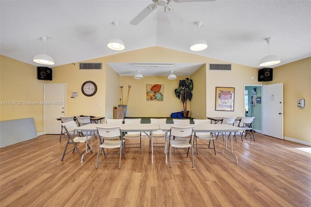 dining area featuring vaulted ceiling, light hardwood / wood-style flooring, and ceiling fan