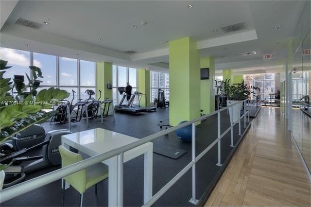 workout area with hardwood / wood-style floors