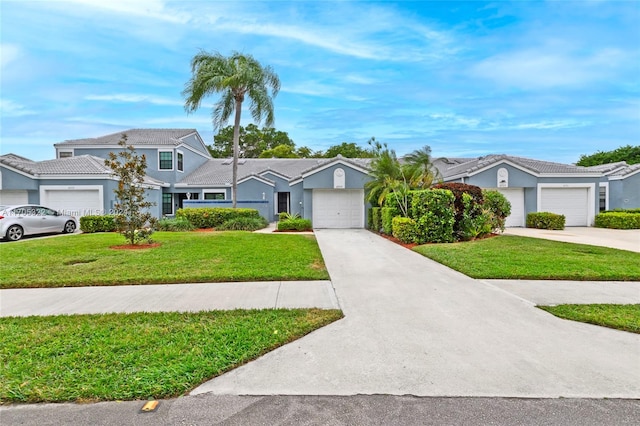 view of front of house featuring a front yard and a garage