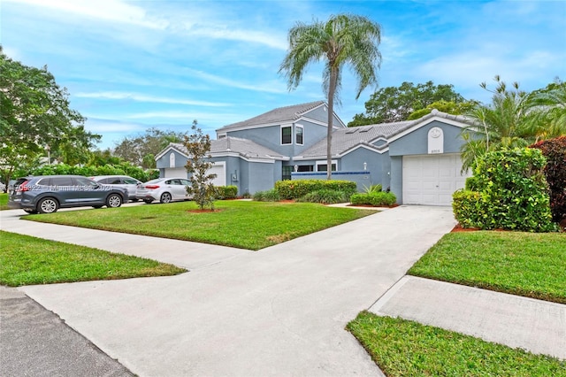 view of front of property featuring a front yard and a garage