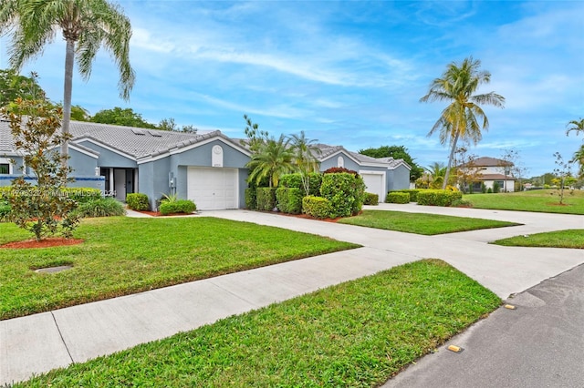 single story home featuring a garage and a front lawn