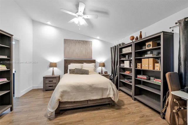 bedroom featuring light wood-type flooring, ceiling fan, and lofted ceiling