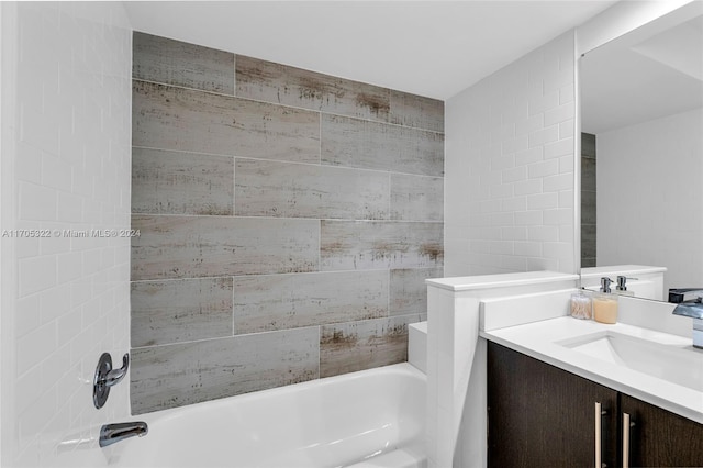 bathroom with a tub to relax in and vanity