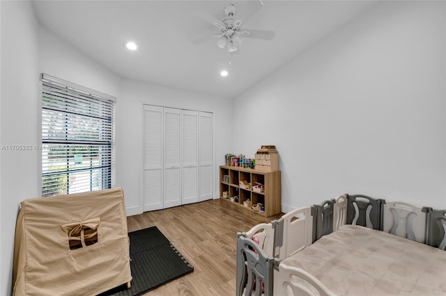 bedroom with ceiling fan, vaulted ceiling, light hardwood / wood-style flooring, and a closet