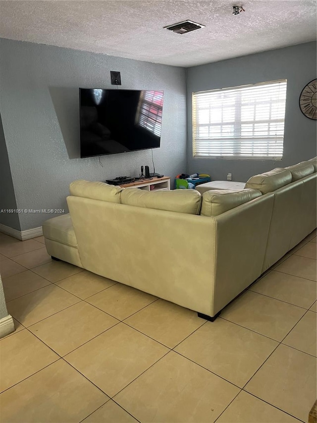 tiled living room with a textured ceiling