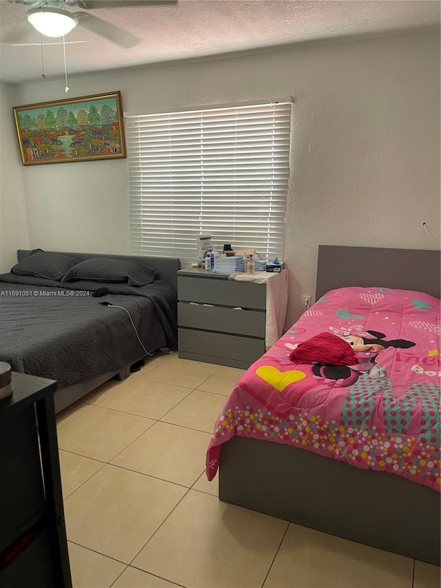 tiled bedroom with ceiling fan