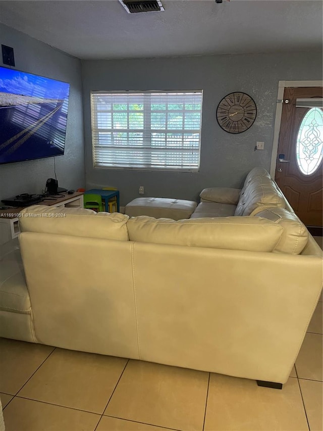 tiled living room with a healthy amount of sunlight