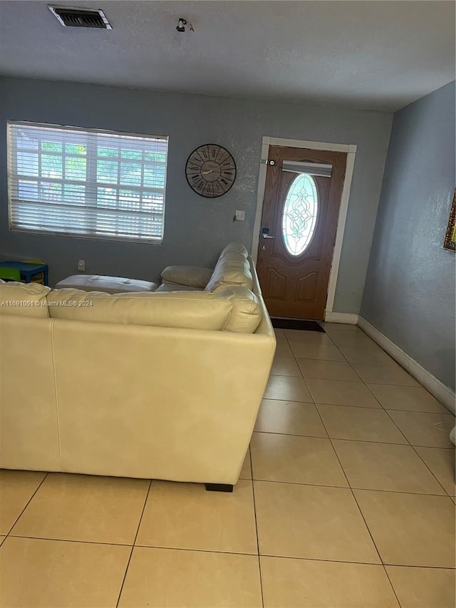 foyer entrance featuring light tile patterned floors