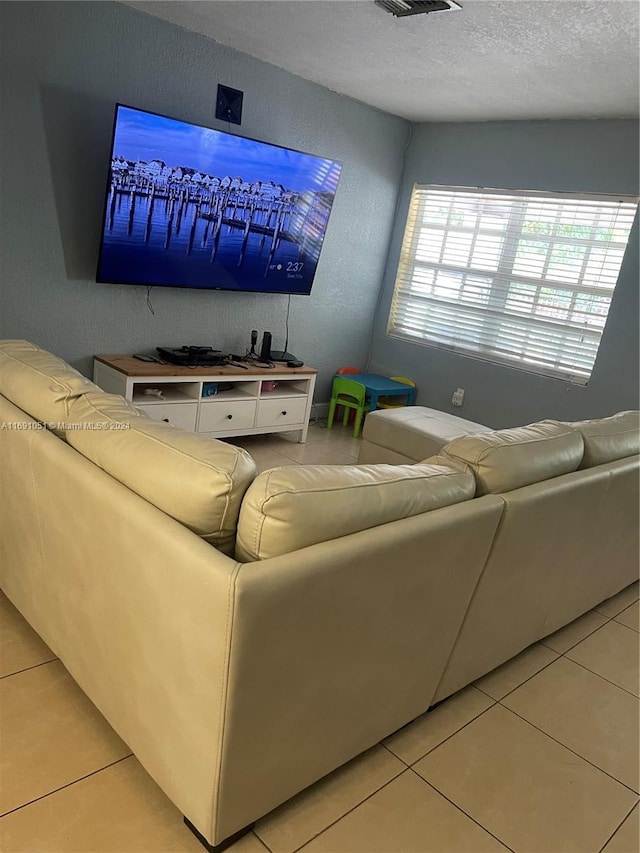 living room featuring light tile patterned floors and a textured ceiling