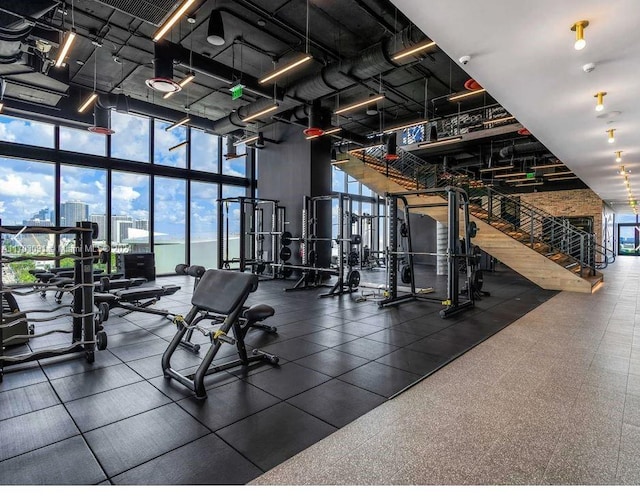 gym featuring a wall of windows and a towering ceiling