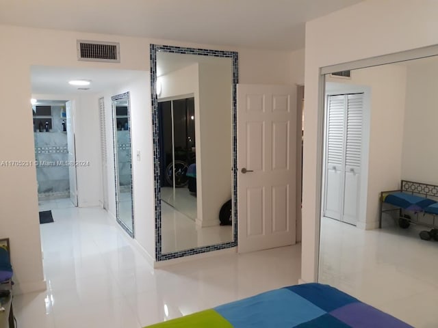 bedroom featuring tile patterned flooring and a closet