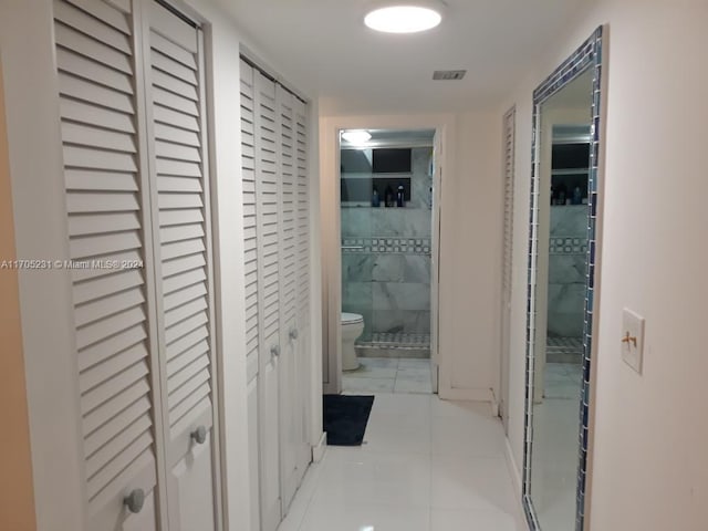 hallway with light tile patterned floors