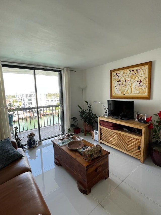 living room with light tile patterned flooring and a water view