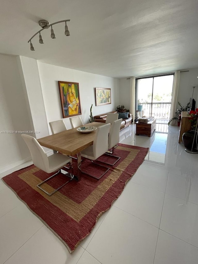 tiled dining area featuring track lighting