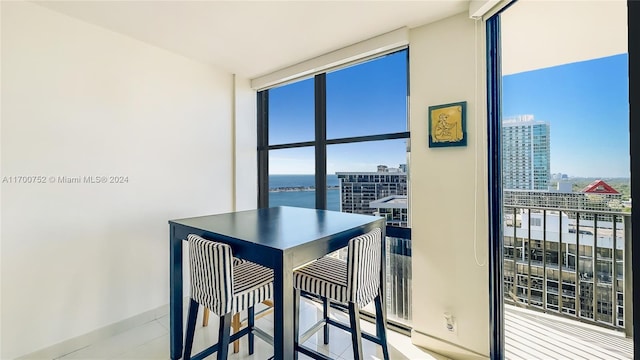 dining area featuring a water view and floor to ceiling windows