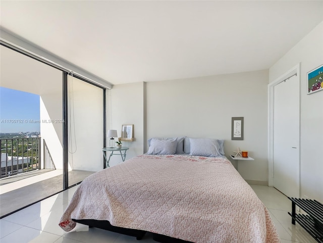 bedroom with light tile patterned floors and a closet