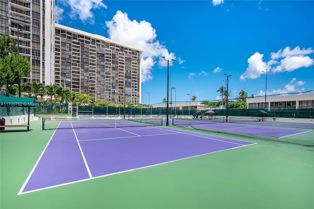 view of tennis court with basketball hoop