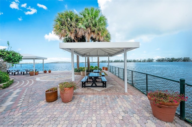 view of patio featuring a gazebo and a water view