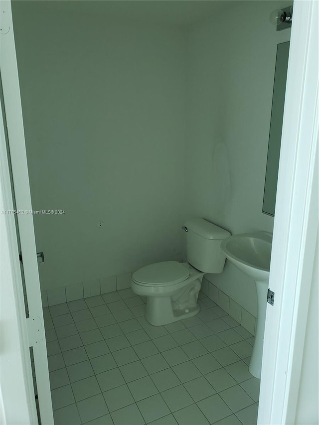 bathroom with tile patterned flooring and toilet