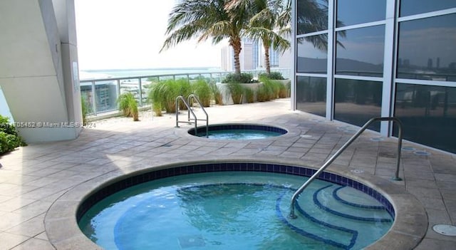 view of swimming pool with a community hot tub