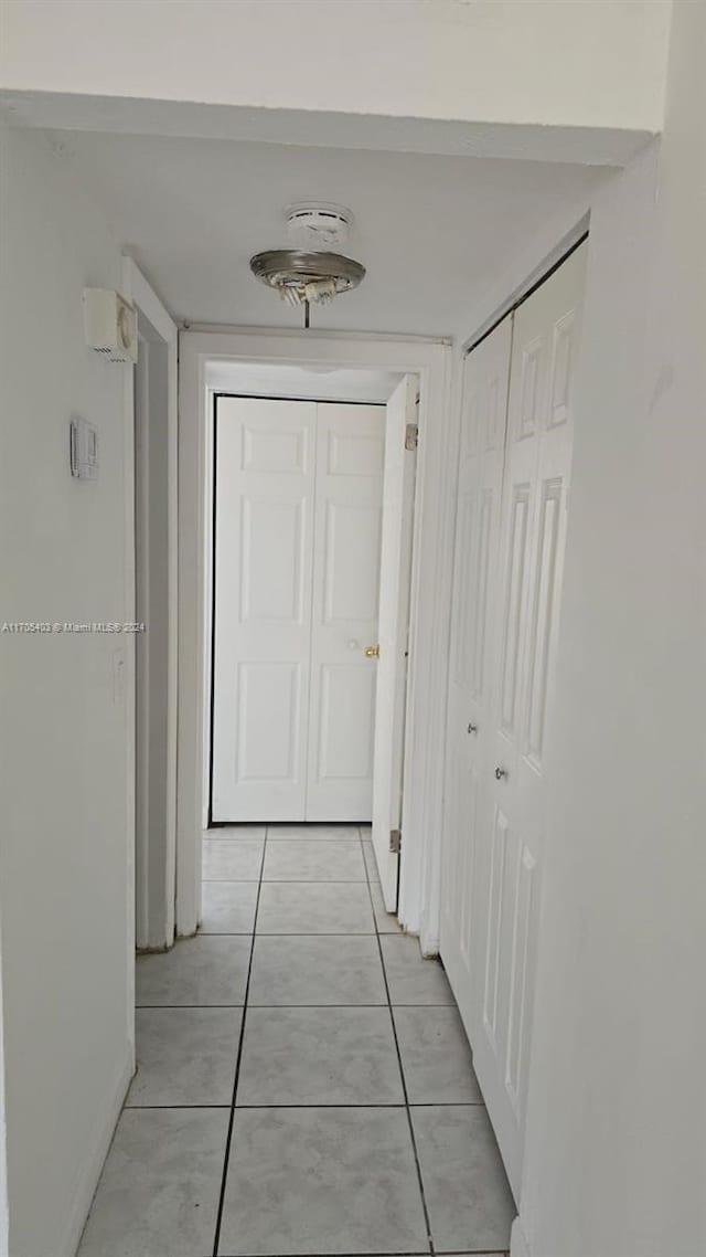 hallway featuring light tile patterned flooring