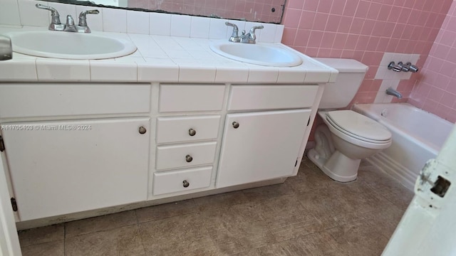 full bathroom with backsplash, vanity, shower / bath combination, and tile walls