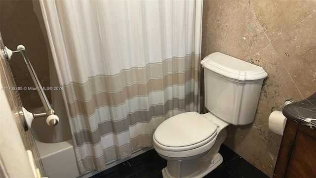 full bathroom featuring tile patterned floors, vanity, tile walls, and shower / tub combo