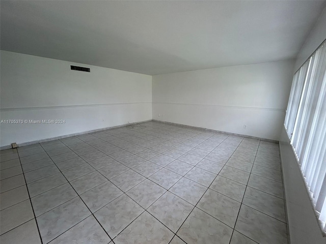 unfurnished room with light tile patterned floors