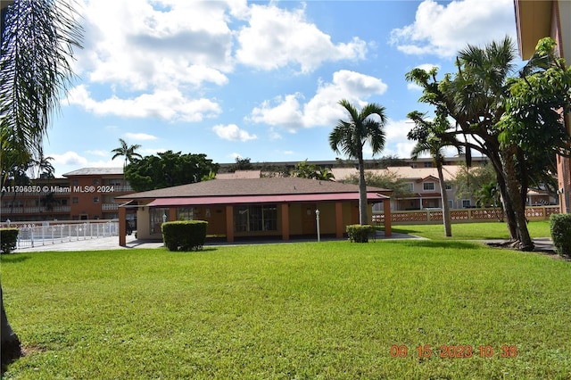 rear view of property with a yard