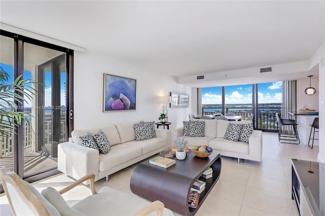 tiled living room featuring a wall of windows