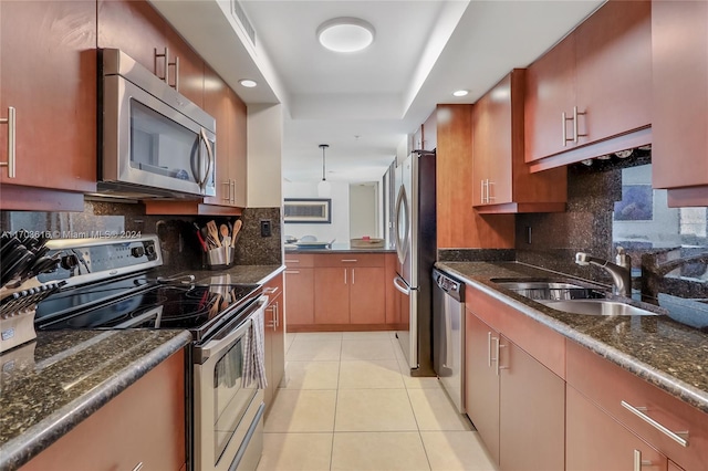 kitchen featuring sink, stainless steel appliances, tasteful backsplash, dark stone countertops, and light tile patterned flooring